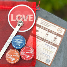 Load image into Gallery viewer, Love Brews Magic set - Captain's, Spicy Papa, Hot Momma, spoon, sticker and card in a red mesh bag